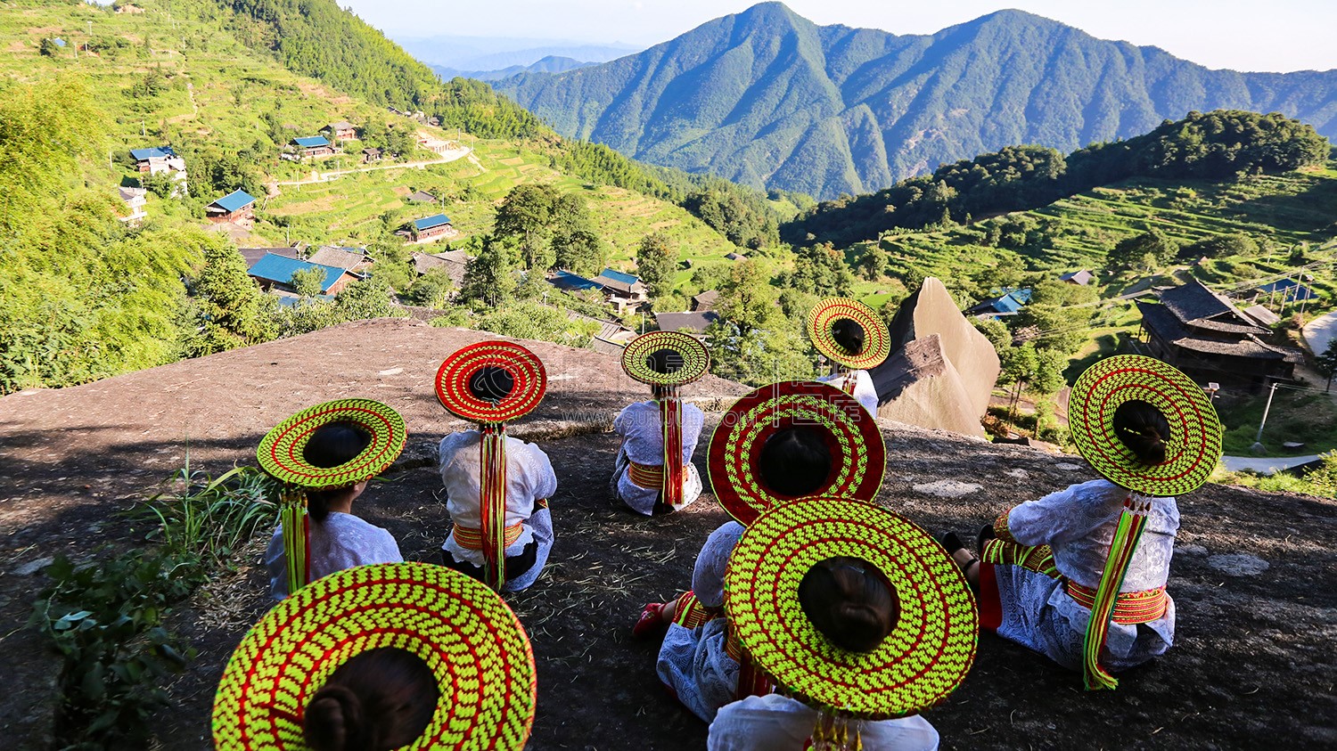 坐在石头上看山脚下的大托村